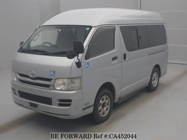 A grey JDM sports car speeding down a highway at night.