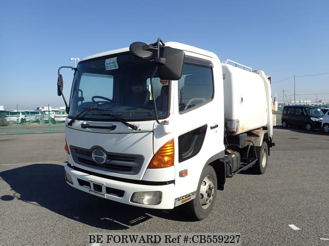 A grey JDM sports car speeding down a highway at night.