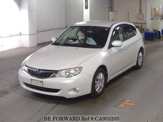 A grey JDM sports car speeding down a highway at night.