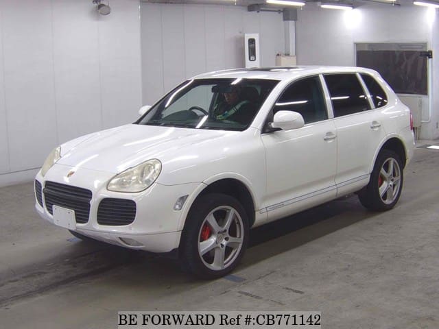 A grey JDM sports car speeding down a highway at night.