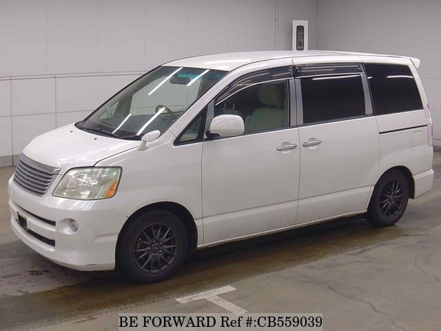 A grey JDM sports car speeding down a highway at night.