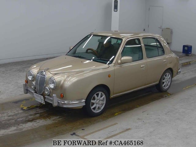 A grey JDM sports car speeding down a highway at night.