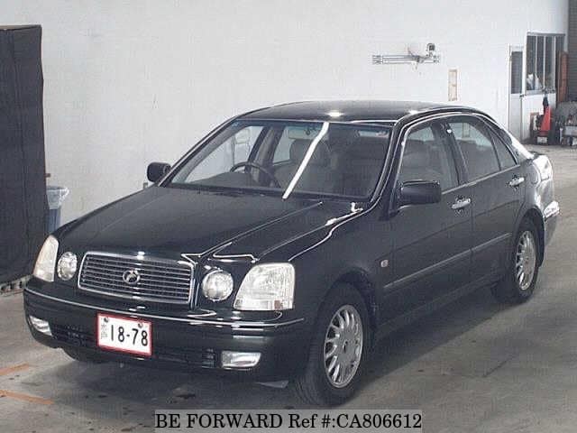 A grey JDM sports car speeding down a highway at night.