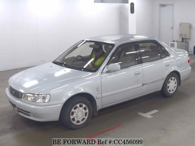 A grey JDM sports car speeding down a highway at night.