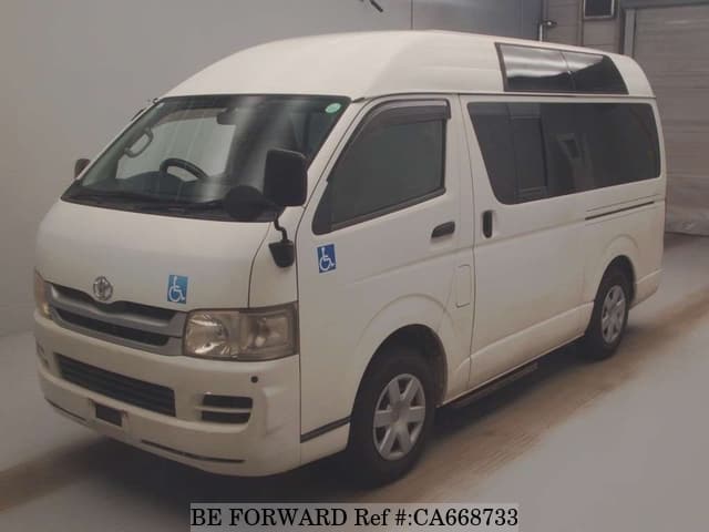 A grey JDM sports car speeding down a highway at night.