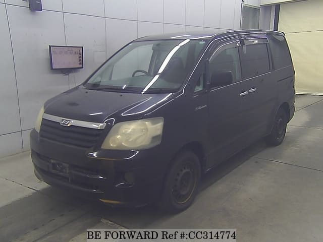 A grey sports car speeding down a highway at night.