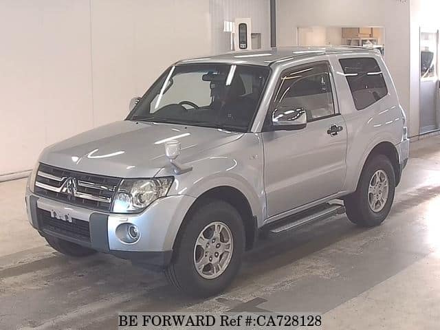 A grey JDM sports car speeding down a highway at night.