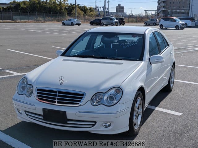 A grey JDM sports car speeding down a highway at night.