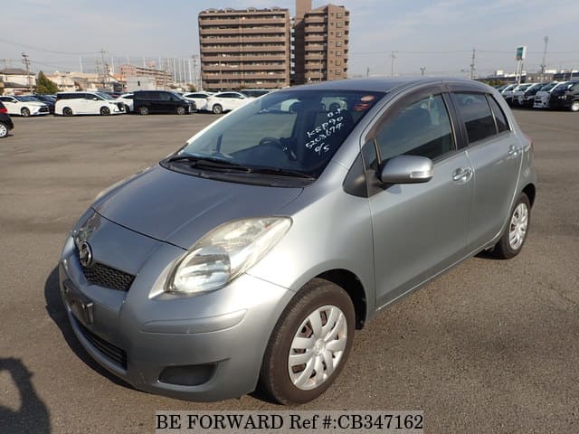 A grey JDM sports car speeding down a highway at night.