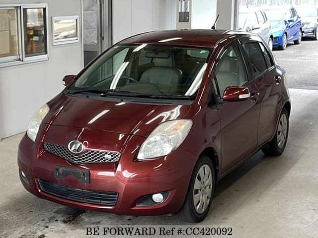 A grey JDM sports car speeding down a highway at night.