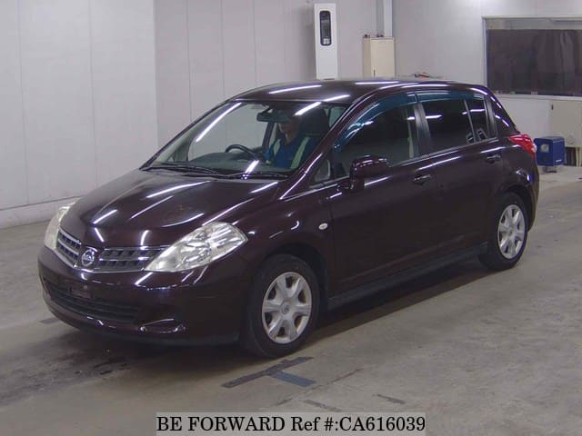 A grey JDM sports car speeding down a highway at night.