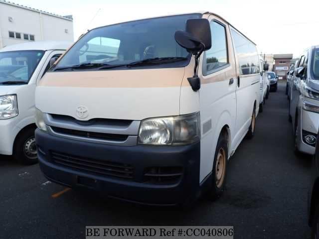 A grey sports car speeding down a highway at night.