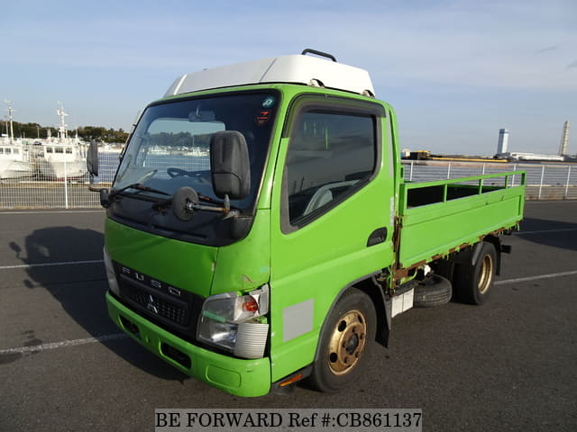 A grey JDM sports car speeding down a highway at night.