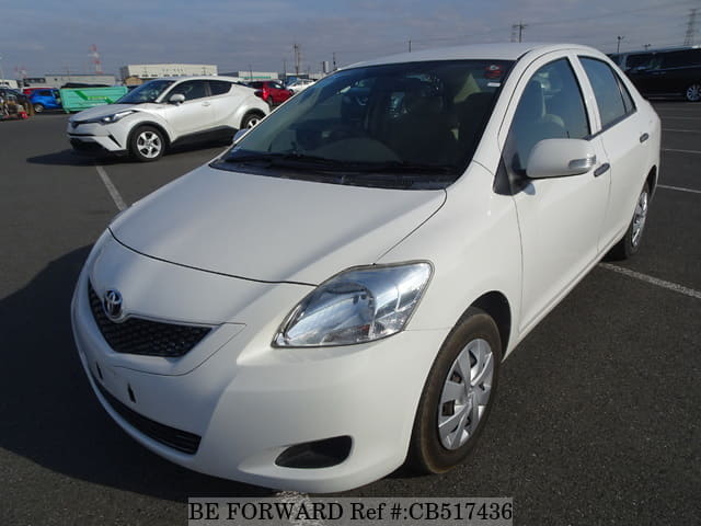 A grey JDM sports car speeding down a highway at night.
