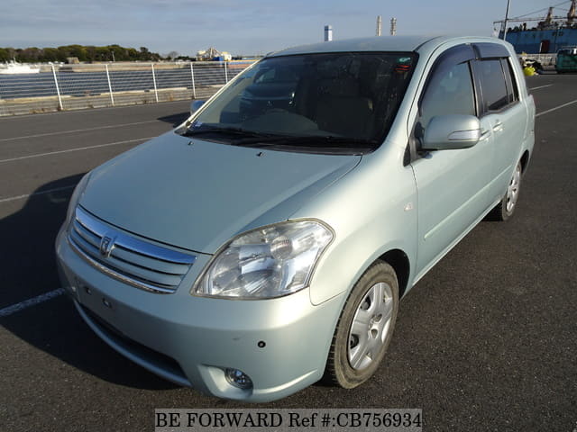 A grey JDM sports car speeding down a highway at night.