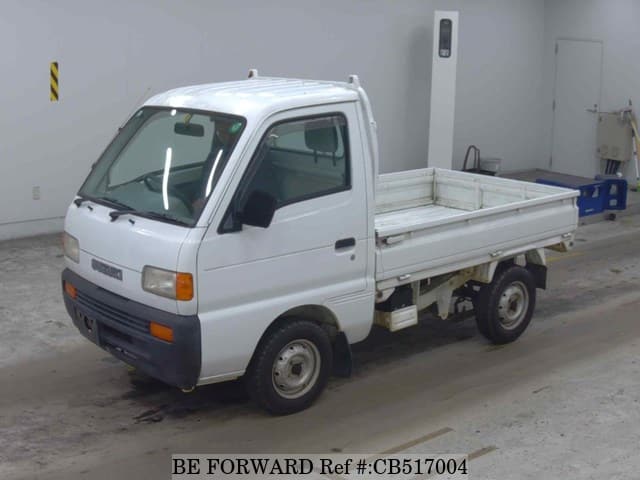 A grey JDM sports car speeding down a highway at night.