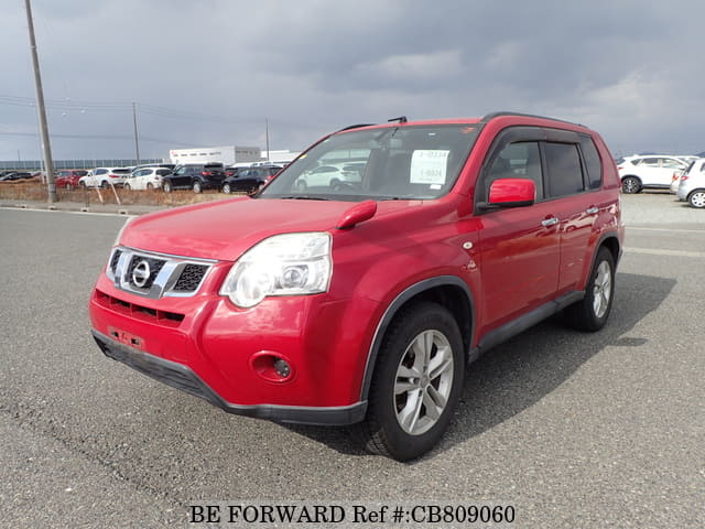 A grey JDM sports car speeding down a highway at night.