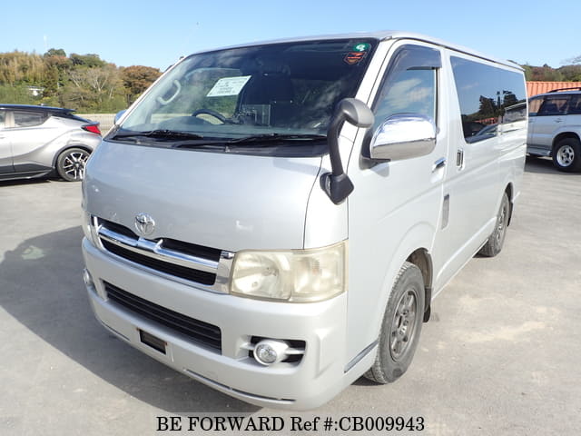 A grey JDM sports car speeding down a highway at night.