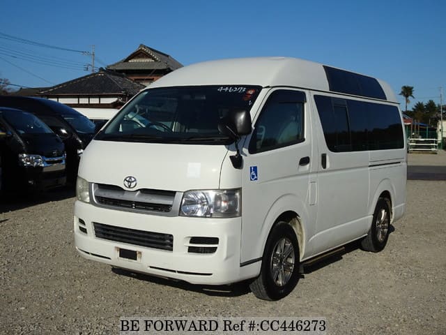 A grey JDM sports car speeding down a highway at night.
