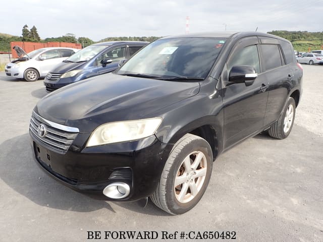 A grey JDM sports car speeding down a highway at night.