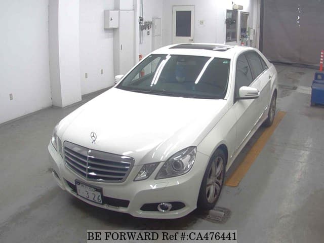 A grey JDM sports car speeding down a highway at night.