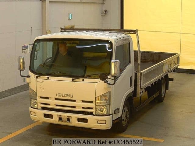 A grey JDM sports car speeding down a highway at night.