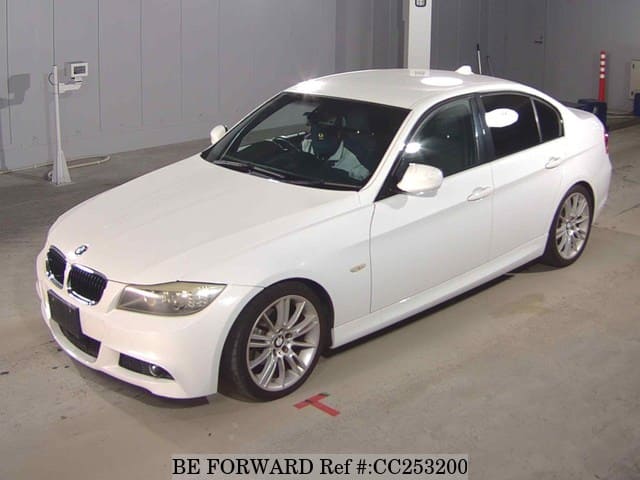 A grey sports car speeding down a highway at night.
