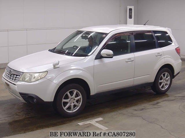 A grey JDM sports car speeding down a highway at night.