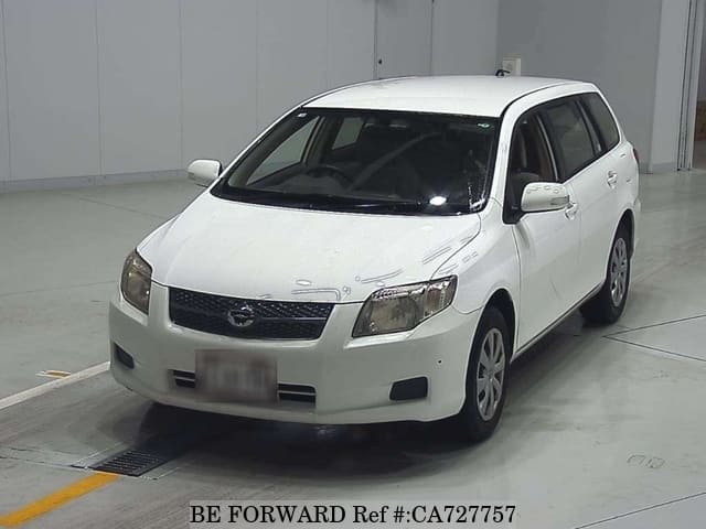 A grey JDM sports car speeding down a highway at night.