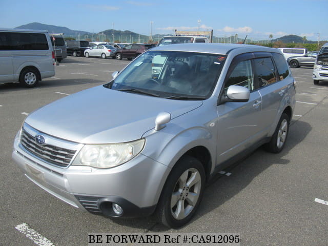 A grey JDM sports car speeding down a highway at night.