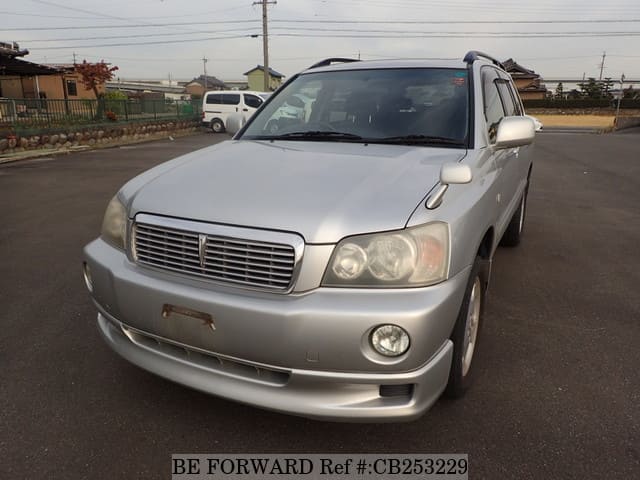 A grey JDM sports car speeding down a highway at night.