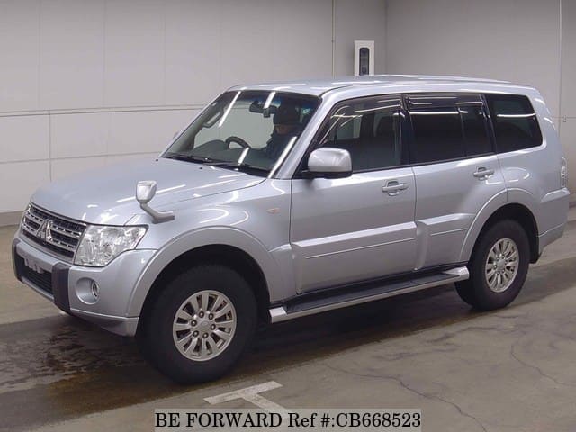 A grey JDM sports car speeding down a highway at night.