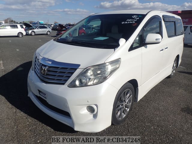 A grey JDM sports car speeding down a highway at night.
