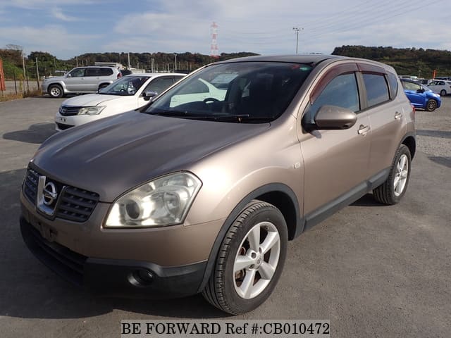 A grey JDM sports car speeding down a highway at night.