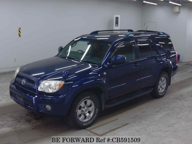 A grey JDM sports car speeding down a highway at night.