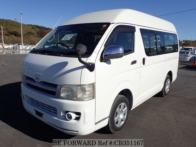A grey JDM sports car speeding down a highway at night.