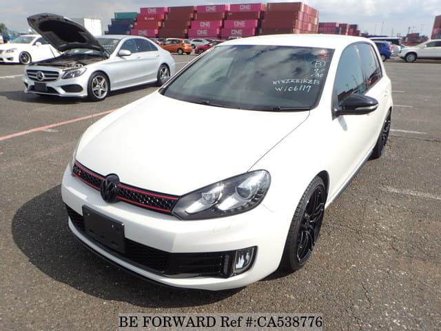 A grey JDM sports car speeding down a highway at night.