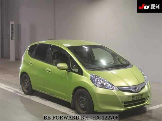 A grey sports car speeding down a highway at night.