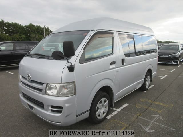 A grey JDM sports car speeding down a highway at night.