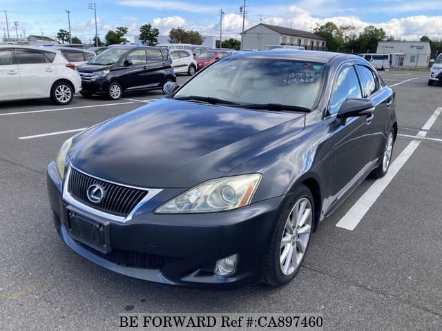 A grey JDM sports car speeding down a highway at night.