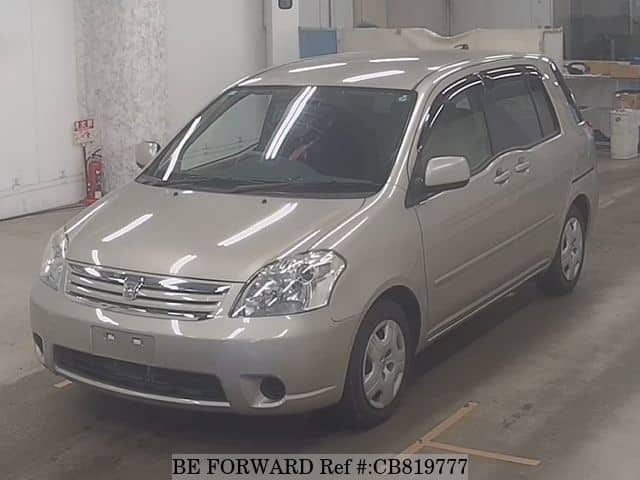 A grey JDM sports car speeding down a highway at night.
