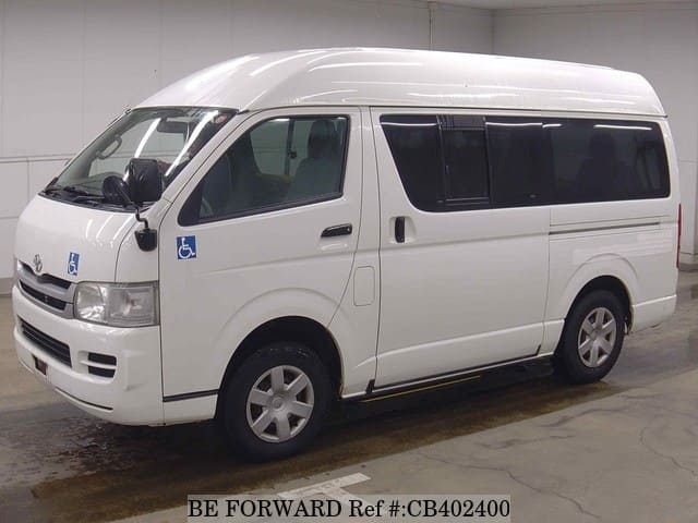 A grey sports car speeding down a highway at night.