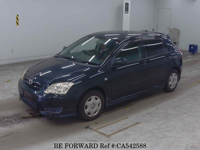 A grey JDM sports car speeding down a highway at night.