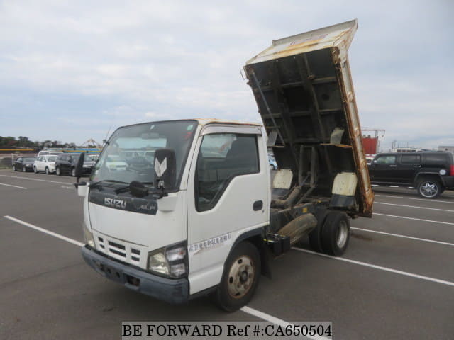 A grey JDM sports car speeding down a highway at night.