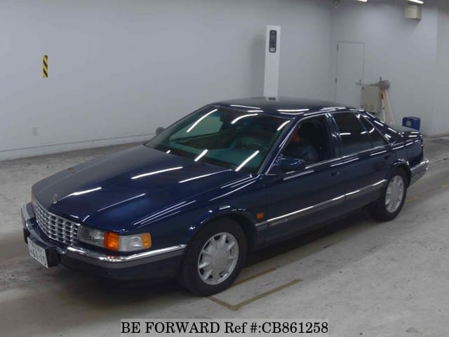 A grey JDM sports car speeding down a highway at night.