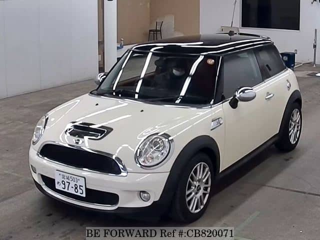 A grey JDM sports car speeding down a highway at night.