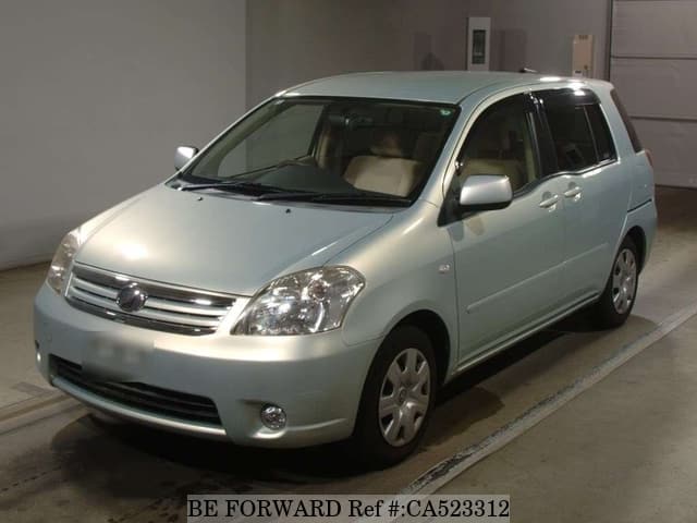 A grey JDM sports car speeding down a highway at night.