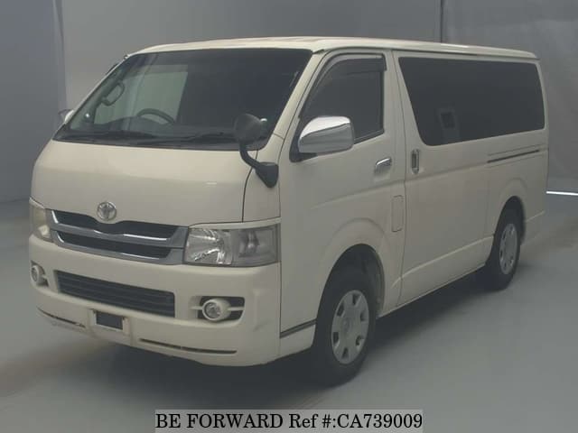 A grey JDM sports car speeding down a highway at night.