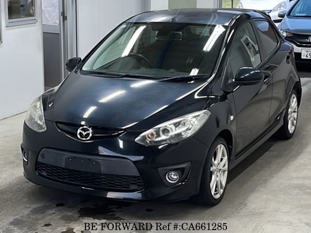 A grey JDM sports car speeding down a highway at night.