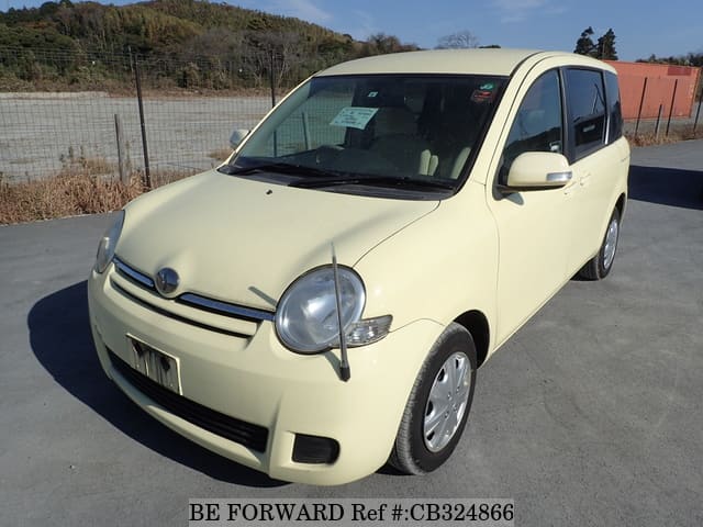 A grey JDM sports car speeding down a highway at night.